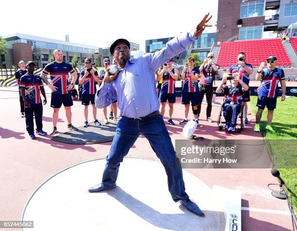 Boxer Lennox Lewis of England demonstrates his shot put ability for Team Great Britain athletes at a training session during the Invictus Games 2017...