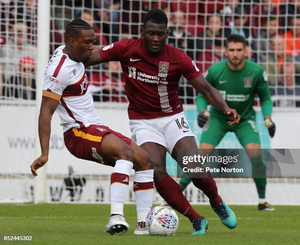 Dominic Poleon of Bradford City looks to play the ball watched by Aaron Pierre of Northampton Town during the Sky Bet League One match between...