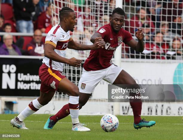 Dominic Poleon of Bradford City looks to play the ball watched by Aaron Pierre of Northampton Town during the Sky Bet League One match between...
