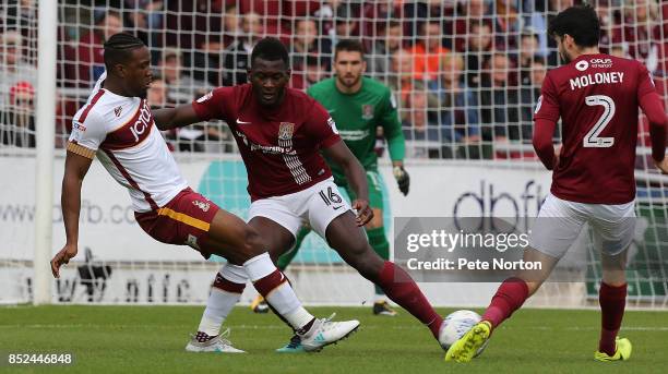 Dominic Poleon of Bradford City plays the ball watched by Aaron Pierre of Northampton Town during the Sky Bet League One match between Northampton...