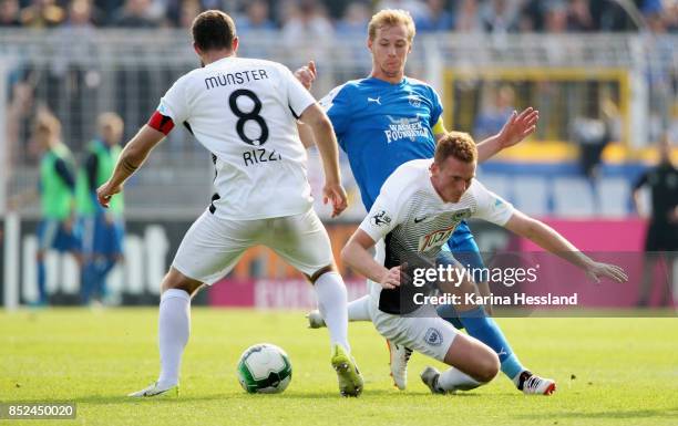 Soeren Eismann of Jena challenges Nico Rinderknecht of Muenster during the 3.Liga match between FC Carl Zeiss Jena and SC Preussen Muenster at...