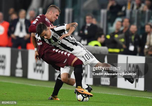 Paulo Exequiel Dybala of Juventus competes for the ball whit Evangelista Lyanco of Torino FC during the Serie A match between Juventus and Torino FC...