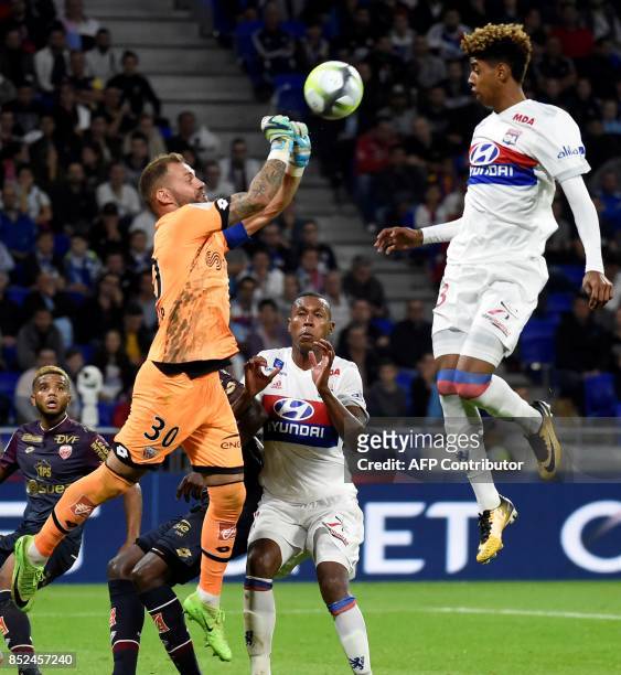 Dijon's French goalkeeper Baptiste Reynet vies with Lyon's forward Willem Geubbels during the French L1 football match Lyon vs Dijon , on September...