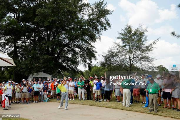 Gary Woodland of the United States plays a shot from a cement path on the first hole during the third round of the TOUR Championship at East Lake...