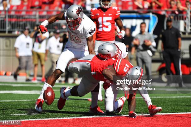 Rashod Berry of the Ohio State Buckeyes fumbles the ball on the goal line after Javin White of the UNLV Rebels stripped the ball in the fourth...