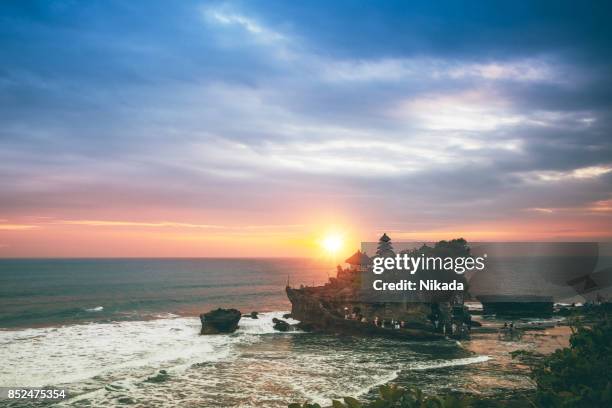 sunset in tanah lot, bali water temple - balinese culture stock pictures, royalty-free photos & images