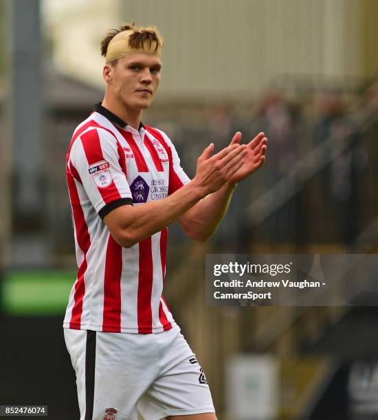 Lincoln City's Sean Raggett applauds the fans at the final whistle following the Sky Bet League Two match between Notts County and Lincoln City at...