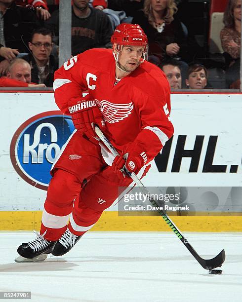 Nicklas Lidstrom of the Detroit Red Wings skates with the puck during a NHL game against the San Jose Sharks on February 25, 2009 at Joe Louis Arena...