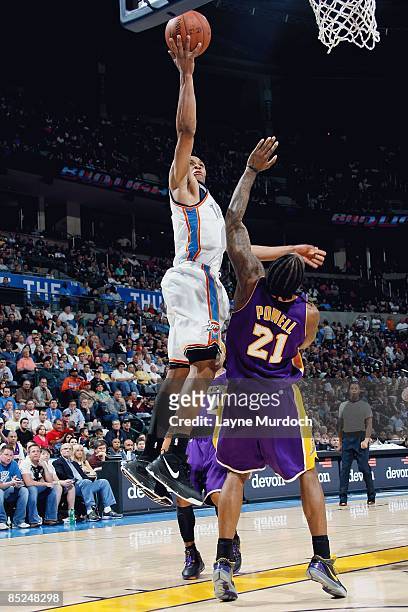 Russell Westbrook of the Oklahoma City Thunder lays the ball up over Josh Powell of the Los Angeles Lakers during the game on February 24, 2009 at...