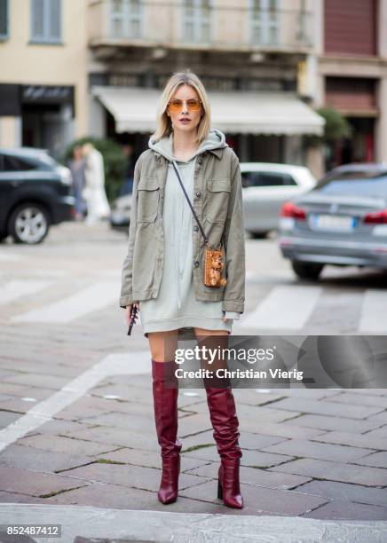 Lisa Hahnbueck wearing Raey Parka, 81 hours sweatshirt, Zara overknee boots, MCM Iphone case is seen outside Philosophy during Milan Fashion Week...