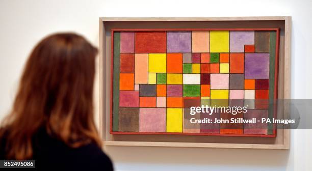 Fan of the German-Swiss Artist Paul Klee studies his work titled Harmony of the Northern Flora, as she tours the Exhibition of his work at the Tate...