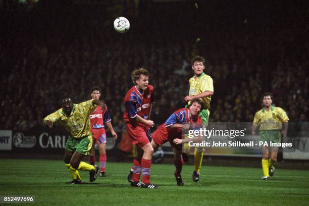 Norwich City's Chris Sutton shoots over the heads of Bayern Munich's Thomas Helmer and Lothar Matthaus. Also pictured for Norwich City is Ruel Fox .