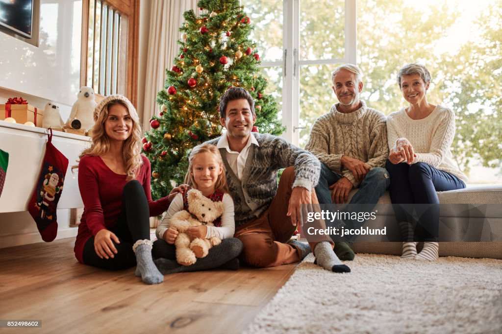 Multi generation family in front of christmas tree