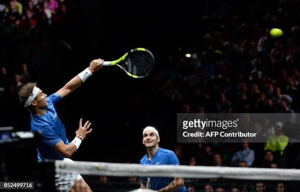 Spain's Rafael Nadal hits a return in front of his teammate of team Europe Switzerland's Roger Federer, during their double tennis match against Team...