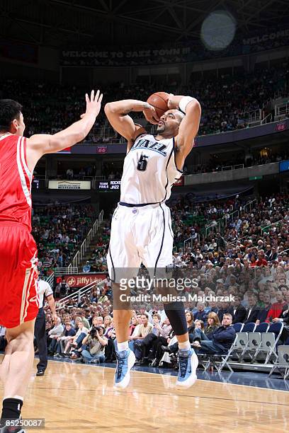 Carlos Boozer of the Utah Jazz goes for the shot as Yao Ming of the Houston Rockets tries to block at EnergySolutions Arena March 4, 2009 in Salt...