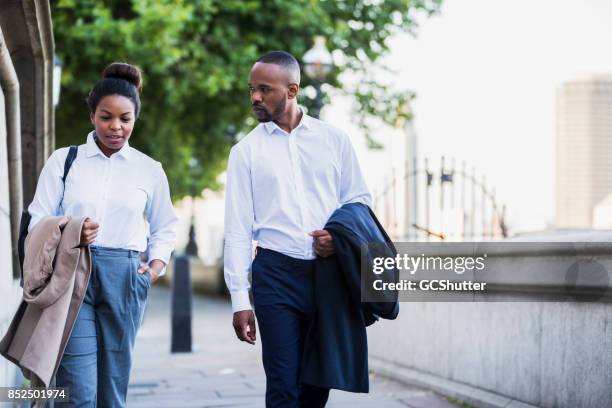 talking while walking along the banks of the thames - river thames walking stock pictures, royalty-free photos & images