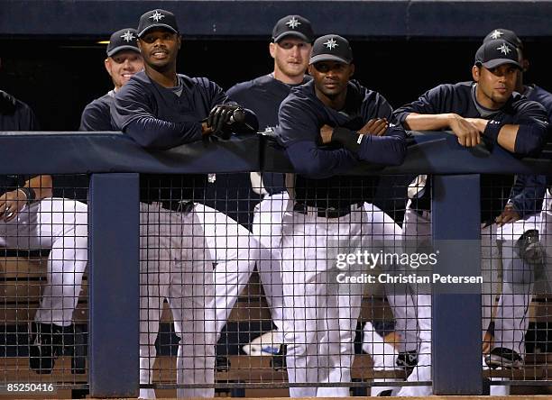 Ken Griffey Jr. #24 of the Seattle Mariners looks on from the dugout during the spring training game against Team Australia at Peoria Stadium on...