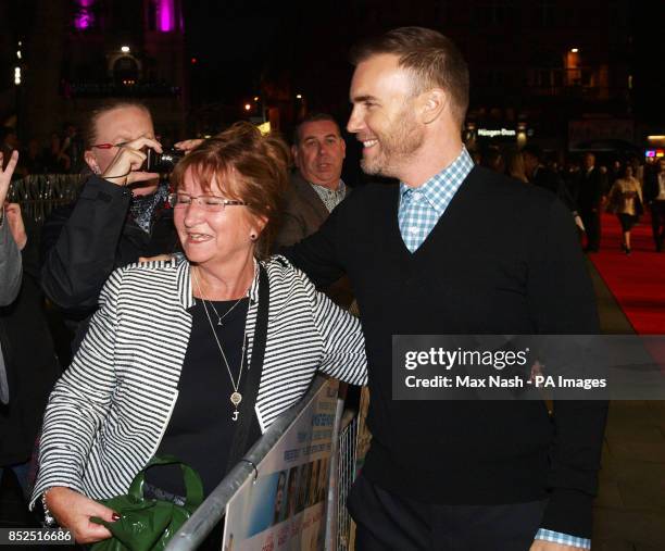 Gary Barlow hugs a fan as he arrives at the premiere of One Chance at the Odeon Leicester Square, central London.