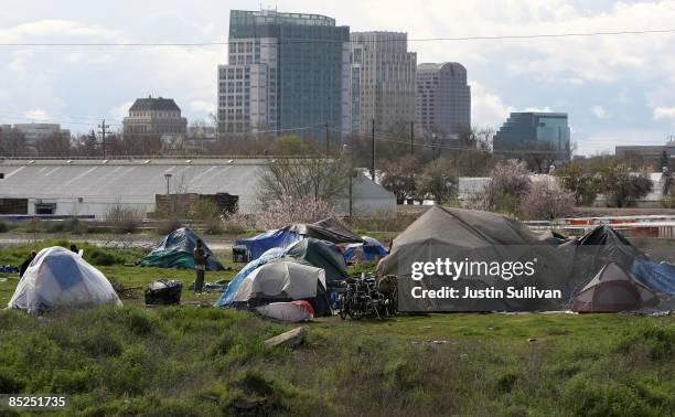 Homeless tent city sits in front of the Sacramento skyline March 4, 2009 in Sacramento, California. The tent city is seeing an increase in population...