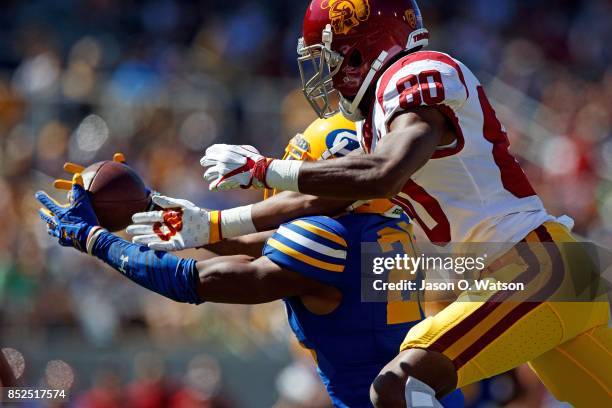 Cornerback Josh Drayden of the California Golden Bears intercepts a pass intended for wide receiver Deontay Burnett of the USC Trojans during the...