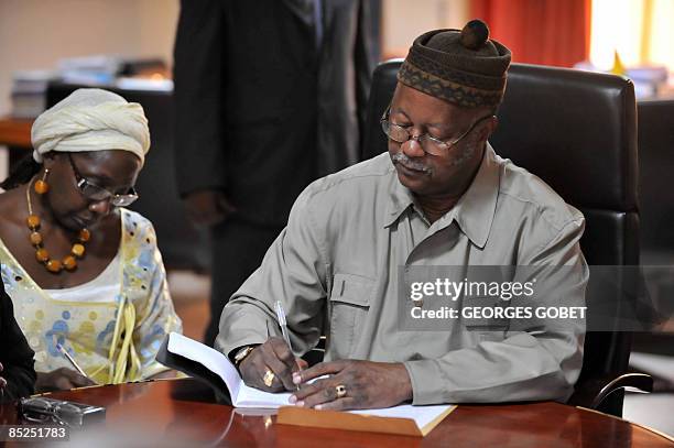 Guinea-Bissau's Prime Minister Carlos Gomes Junior takes notes during a visit by a ECOWAS delegation in Bissau on March 4, 2009. The West African...
