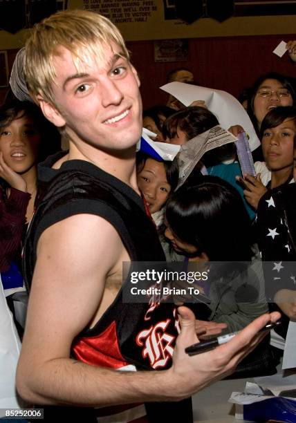 Pop singer Aaron Carter poses with fans at The Hollywood Knights celebrity basketball game at El Monte High School on March 4, 2009 in El Monte,...