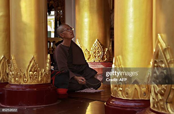 This picture taken on March 2, 2009 shows a nun praying at the Shwe Dagon Pagoda in Yangon. Authorities in Myanmar have warned people to be on alert...