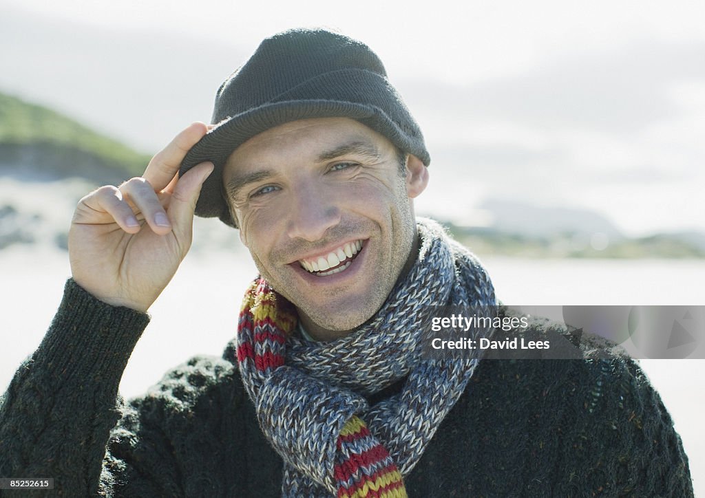 Portrait of man on beach, smiling, close up