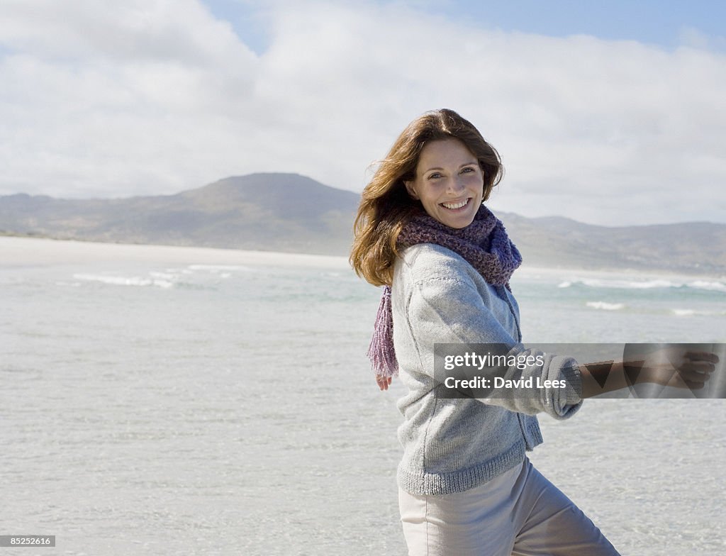Woman on beach, portrait, smiling