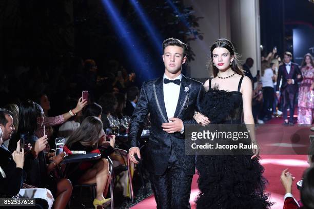 Cameron Dallas and Sonia Ben Ammar walk the runway at the Dolce & Gabbana secret show during Milan Fashion Week Spring/Summer 2018 at Bar Martini on...