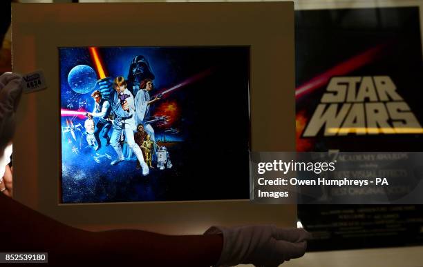 Valuer Kathy Taylor holding an original Star Wars acetate transparency used in the production of the original Tom Chantrell poster, which is to be...