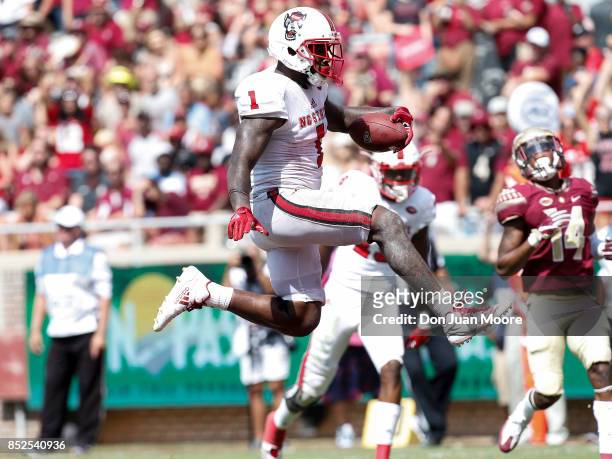 Tightend Jaylen Samuels of the North Carolina State Wolfpack leaps in the air after making a touchdown during the game against the Florida State...