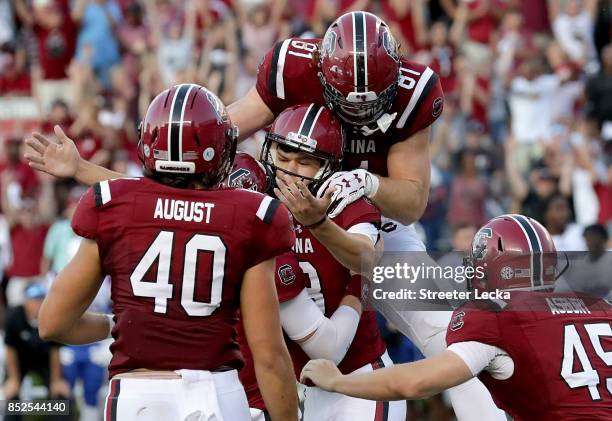 Parker White of the South Carolina Gamecocks celebrates with teammates after kicking the game winning field goal to defeat the Louisiana Tech...