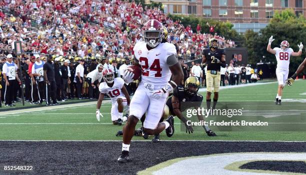 Brian Robinson Jr. #24 of the Alabama Crimson Tide scores a touchdown against the Vanderbilt Commodores during the second half at Vanderbilt Stadium...