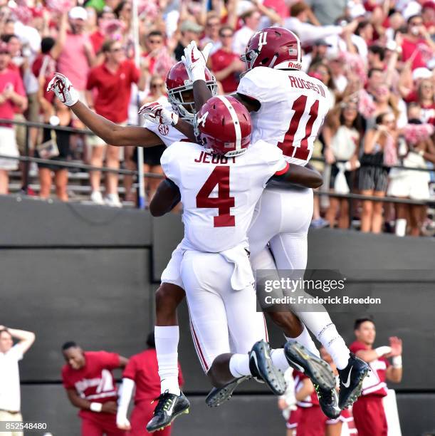 Jerry Jeudy and Henry Ruggs III of the Alabama Crimson Tide celebrates with DeVonta Smith after his scoring a touchdown against the Vanderbilt...