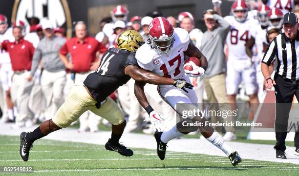 Ryan White of the Vanderbilt Commodores tackles Cam Sims of the Alabama Crimson Tide during the first half at Vanderbilt Stadium on September 23,...