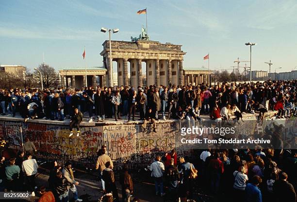 Crowds at the Brandenburg Gate bear witness to the Fall of the Berlin Wall, 10th November 1989.