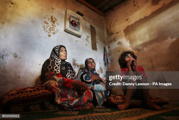 Syrian refugee Fauza Hamid who fled an attack that left sixteen of her neighbours dead, sits with family members at the Dahb El Sim refugee camp in...