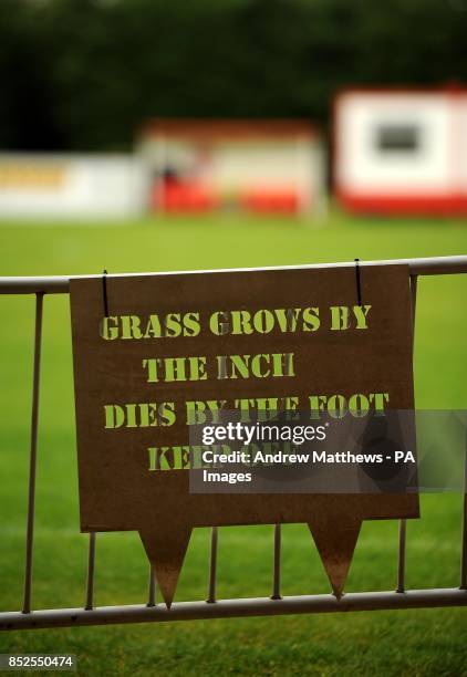 Novel Keep off the Grass sign is displayed at St James Park prior to the FA Cup, Fourth Qualifying Round match at St James Park, Brackley.