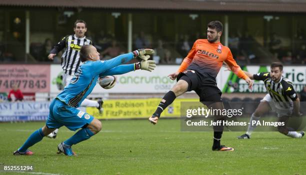 Dundee United's Nadir Ciftci beats Marion Kello to score first goal during the Scottish Premier League match at Tannadice Park, Dundee.