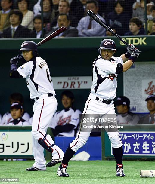 Outfielder Ichiro Suzuki and Infielder Hiroyuki Nakajima of Japan warm up during the World Baseball Classic Tokyo Round match between Japan and China...