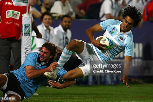 Martin Bustos Moyano of Argentina is tackled during the Pool F match between Argentina and Uruguay at the IRB Rugby World Cup Sevens 2009 at The...