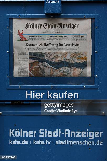 Detail view of the Newspapers automat with the headline saying 'Sinking chances for missing persons' is seen two days after the colapse of the...