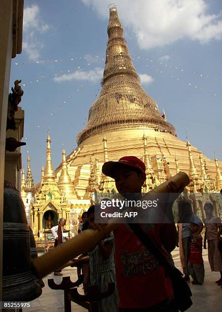 This picture taken on March 2, 2009 shows a boy hiting a bell at the Shwe Dagon Pagoda in Yangon. Authorities in Myanmar have warned people to be on...