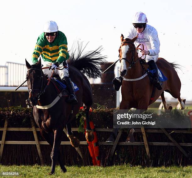 Simply Blue ridden by Andrew Glassonbury jumps the last to go on to win The Steven & Roy Hanney Memorial Handicap Hurdle Race at Wincanton Races on...