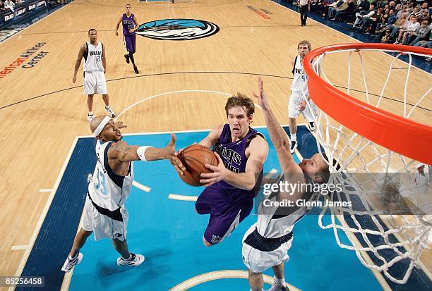 Beno Udrih of the Sacramento Kings puts up a shoot between James Singleton and Jose Barea of the Dallas Mavericks during the game on February 21,...