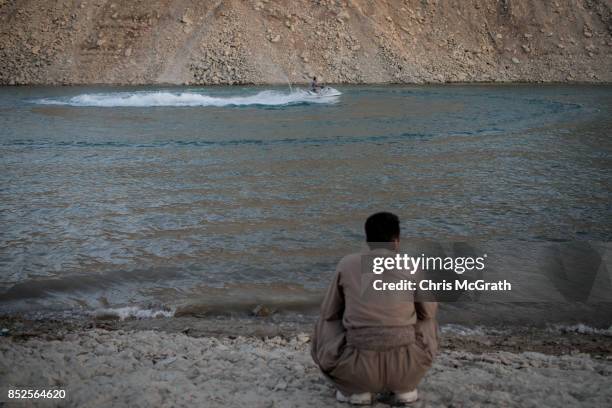 Man watches people use a jet ski ahead of the upcoming referendum for independence of Kurdistan on September 23, 2017 in Sulaymaniyah, Iraq. The...