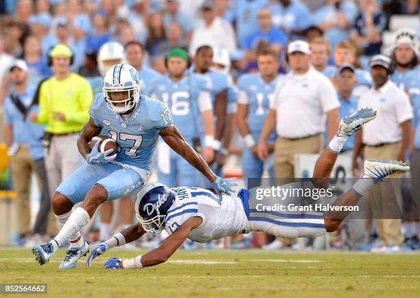 Jordan Hayes of the Duke Blue Devils dives to tackle Anthony Ratliff-Williams of the North Carolina Tar Heels during their game at Kenan Stadium on...