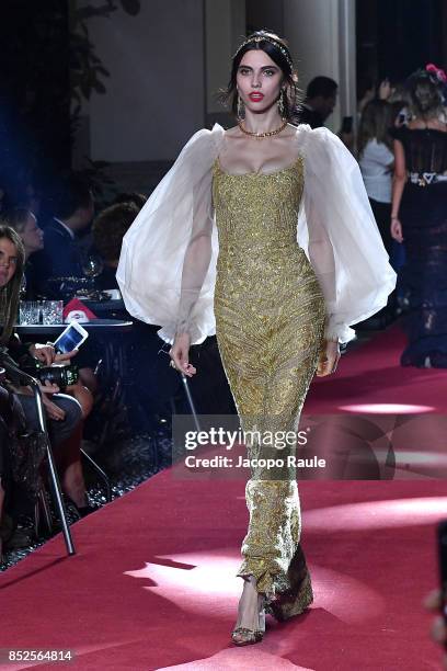 Model walks the runway at the Dolce & Gabbana secret show during Milan Fashion Week Spring/Summer 2018 at Bar Martini on September 23, 2017 in Milan,...