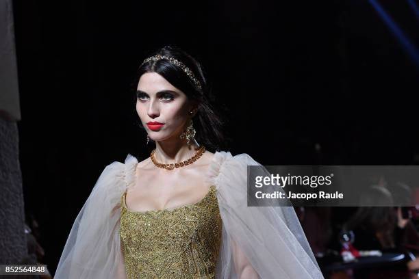 Model walks the runway at the Dolce & Gabbana secret show during Milan Fashion Week Spring/Summer 2018 at Bar Martini on September 23, 2017 in Milan,...